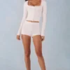 Amoura Knit Mid-Rise Mini Shorts in Ivory