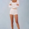 Amoura Knit Mid-Rise Mini Shorts in Ivory