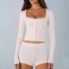 Amoura Knit Mid-Rise Mini Shorts in Ivory