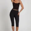 Armelia Embellished Peekaboo Cowl-Neck Top in Black