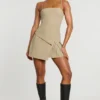 Bruna Woven Twill Wrap Over Pleated Mini Dress in Taupe