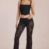 Calista Sheer Lace Mid-Rise Flared Trousers in Black