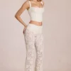 Calista Sheer Lace Mid-Rise Flared Trousers in Ivory