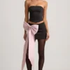 Carola Satin Bow-Detail Low-Rise Mini Skirt in Black