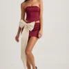 Carola Satin Bow-Detail Low-Rise Mini Skirt in Wine Red
