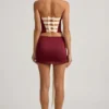Carola Satin Bow-Detail Low-Rise Mini Skirt in Wine Red