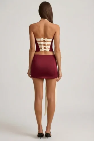 Carola Satin Bow-Detail Low-Rise Mini Skirt in Wine Red