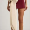 Carola Satin Bow-Detail Low-Rise Mini Skirt in Wine Red