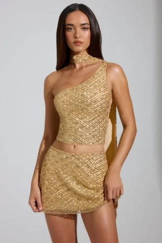 Cosette Embellished Asymmetric Scarf-Detail Top in Gold