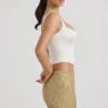 Jianna Embellished Low-Rise Mini Skirt in Gold