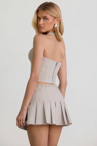 Laika Low-Rise Pleated Mini Skirt in Ecru