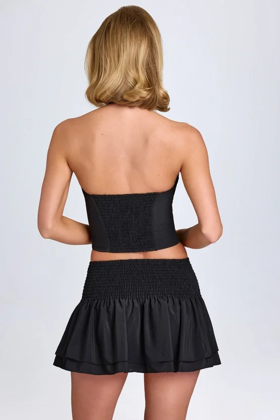 Nellary Ruffled Shirred Low-Rise Micro Mini Skirt in Black Nellary Ruffled Shirred Low-Rise Micro Mini Skirt in Black