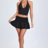 Nellary Ruffled Shirred Low-Rise Micro Mini Skirt in Black Nellary Ruffled Shirred Low-Rise Micro Mini Skirt in Black