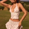 Nellary Ruffled Shirred Low-Rise Micro Mini Skirt in Small Rose Print