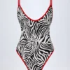 Ostend Charm-Detail Cross-Back Swimsuit in Zebra Print