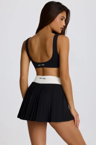 Soft Active Crossover Pleated Mini Skort in Black