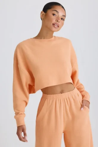Textured Cotton Jersey Open-Back Cropped Sweatshirt in Peach