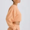 Textured Cotton Jersey Open-Back Cropped Sweatshirt in Peach