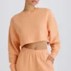 Textured Cotton Jersey Open-Back Cropped Sweatshirt in Peach