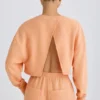 Textured Cotton Jersey Open-Back Cropped Sweatshirt in Peach
